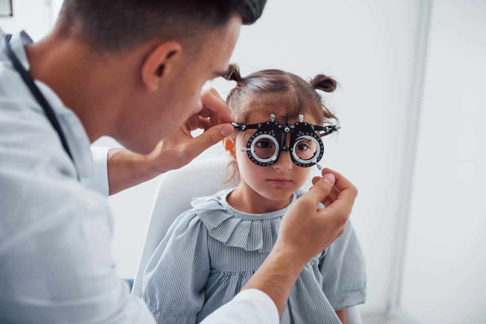 Young Ophthalmologist Is With Little Female Visitor