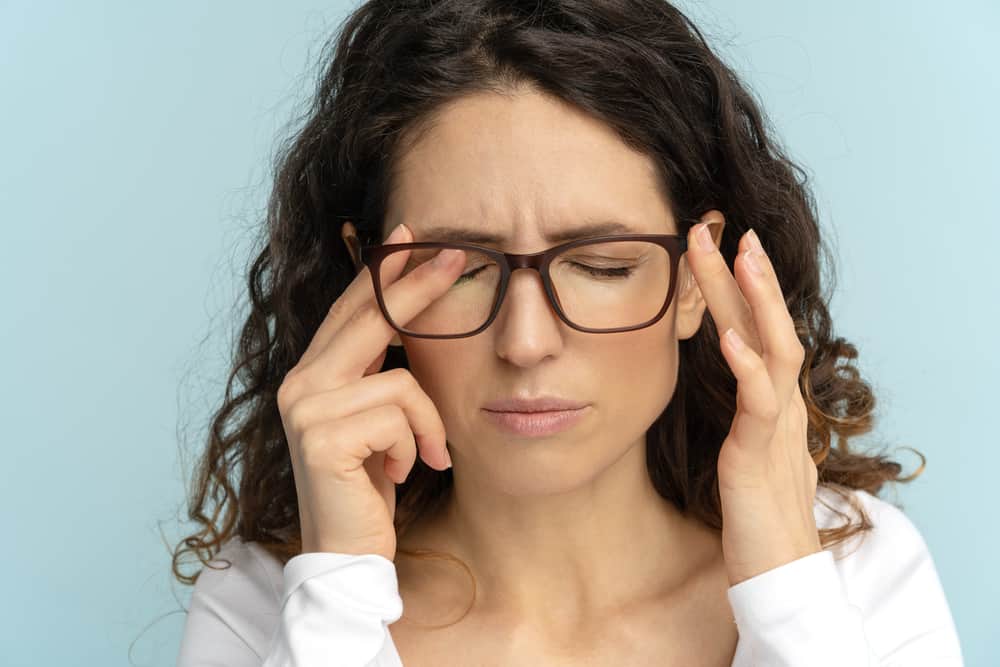 woman touching her eyes