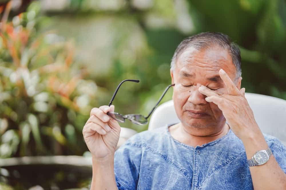 An Elderly Man Rubbing His Eyes